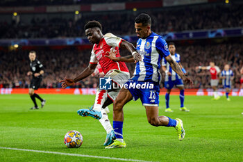 2024-03-13 - Bukayo Saka (7) of Arsenal tussles with Galeno (13) of FC Porto during the UEFA Champions League, Round of 16, 2nd leg football match between Arsenal and FC Porto on 12 March 2024 at the Emirates Stadium in London, England - FOOTBALL - CHAMPIONS LEAGUE - ARSENAL V PORTO - UEFA CHAMPIONS LEAGUE - SOCCER
