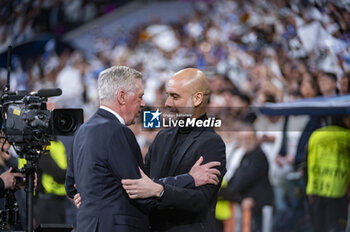 2024-04-09 - Carlo Ancelotti (L), coach of Real Madrid, hugs Josep Pep Guardiola (R), head coach of Manchester City, before the UEFA Champions League quarter-final first leg match between Real Madrid CF and Manchester City at Estadio Santiago Bernabeu on April 9, 2024 in Madrid, Spain. - REAL MADRID VS MANCHESTER CITY - UEFA CHAMPIONS LEAGUE - SOCCER