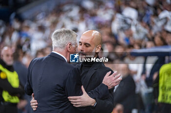 2024-04-09 - Carlo Ancelotti (L), coach of Real Madrid, hugs Josep Pep Guardiola (R), head coach of Manchester City, before the UEFA Champions League quarter-final first leg match between Real Madrid CF and Manchester City at Estadio Santiago Bernabeu on April 9, 2024 in Madrid, Spain. - REAL MADRID VS MANCHESTER CITY - UEFA CHAMPIONS LEAGUE - SOCCER