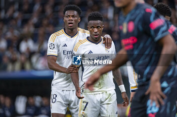 2024-04-09 - Aurelien Tchouameni of Real Madrid (L) and Vinicius Junior of Real Madrid (R) during the UEFA Champions League quarter-final first leg match between Real Madrid CF and Manchester City at Estadio Santiago Bernabeu on April 9, 2024 in Madrid, Spain. - REAL MADRID VS MANCHESTER CITY - UEFA CHAMPIONS LEAGUE - SOCCER