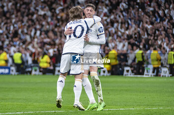 2024-04-09 - Luka Modric of Real Madrid (L) hugs Federico Valverde of Real Madrid (R) that celebrates his goal during the UEFA Champions League quarter-final first leg match between Real Madrid CF and Manchester City at Estadio Santiago Bernabeu on April 9, 2024 in Madrid, Spain. - REAL MADRID VS MANCHESTER CITY - UEFA CHAMPIONS LEAGUE - SOCCER