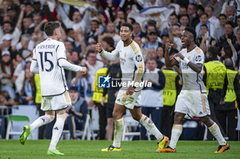 2024-04-09 - Federico Valverde of Real Madrid (L) celebrates a goal with Jude Bellingham (C) and Vinicius Junior (R) during the UEFA Champions League quarter-final first leg match between Real Madrid CF and Manchester City at Estadio Santiago Bernabeu on April 9, 2024 in Madrid, Spain. - REAL MADRID VS MANCHESTER CITY - UEFA CHAMPIONS LEAGUE - SOCCER