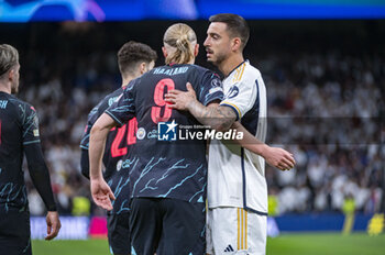 2024-04-09 - Jose Luis Sanmartin Mato (Joselu) of Real Madrid (R) hugs Erling Haaland of Manchester City (L) during the UEFA Champions League quarter-final first leg match between Real Madrid CF and Manchester City at Estadio Santiago Bernabeu on April 9, 2024 in Madrid, Spain. - REAL MADRID VS MANCHESTER CITY - UEFA CHAMPIONS LEAGUE - SOCCER