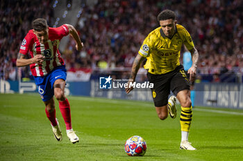 2024-04-10 - Jadon Sancho of Borussia Dortmund (R) seen in action with the ball against Nahuel Molina of Atletico Madrid (L) during the UEFA Champions League quarter-final first leg match between Atletico Madrid and Borussia Dortmund at Estadio Civitas Metropolitano on April 10, 2024 in Madrid, Spain. - ATLETICO MADRID VS BORUSSIA DORTMUND - UEFA CHAMPIONS LEAGUE - SOCCER