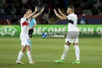 2024-04-16 - Vitinha and Kylian Mbappe of PSG celebrate the victory following the UEFA Champions League, Quarter-finals, 2nd leg football match between FC Barcelona and Paris Saint-Germain (PSG) on April 16, 2024 at Estadi Olímpic Lluís Companys in Barcelona, Spain - FOOTBALL - CHAMPIONS LEAGUE - FC BARCELONA V PARIS SG - UEFA CHAMPIONS LEAGUE - SOCCER