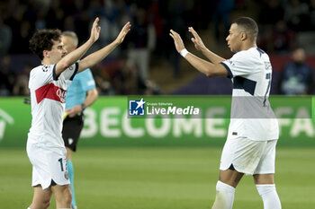 2024-04-16 - Vitinha and Kylian Mbappe of PSG celebrate the victory following the UEFA Champions League, Quarter-finals, 2nd leg football match between FC Barcelona and Paris Saint-Germain (PSG) on April 16, 2024 at Estadi Olímpic Lluís Companys in Barcelona, Spain - FOOTBALL - CHAMPIONS LEAGUE - FC BARCELONA V PARIS SG - UEFA CHAMPIONS LEAGUE - SOCCER