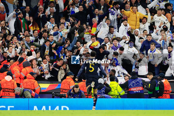 2024-04-17 - Jude Bellingham (5) of Real Madrid runs to the fans as he celebrates the penalty shoot out victory at the end of the UEFA Champions League, Quarter-finals, 2nd leg football match between Manchester City and Real Madrid on April 17, 2024 at Etihad Stadium in Manchester, England - FOOTBALL - CHAMPIONS LEAGUE - MANCHESTER CITY V REAL MADRID - UEFA CHAMPIONS LEAGUE - SOCCER