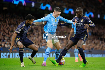 2024-04-17 - Phil Foden (47) of Manchester City is challenged by Ferland Mendy (23) and Rodrygo Goes (11) of Real Madrid during the UEFA Champions League, Quarter-finals, 2nd leg football match between Manchester City and Real Madrid on April 17, 2024 at Etihad Stadium in Manchester, England - FOOTBALL - CHAMPIONS LEAGUE - MANCHESTER CITY V REAL MADRID - UEFA CHAMPIONS LEAGUE - SOCCER