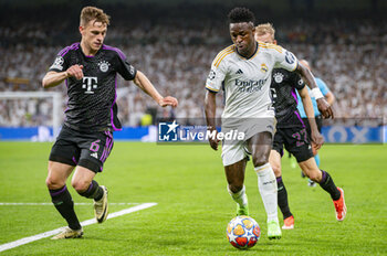 2024-05-08 - MADRID, SPAIN - MAY 8: Vinicius Junior of Real Madrid (R) seen in action against Joshua Kimmich of FC Bayern Munchen (L) during the UEFA Champions League semi-final second leg match between Real Madrid and FC Bayern Munchen at Estadio Santiago Bernabeu on May 8, 2024 in Madrid, Spain. - REAL MADRID VS BAYERN MUNICH - UEFA CHAMPIONS LEAGUE - SOCCER