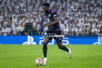 2024-05-08 - MADRID, SPAIN - MAY 8: Alphonso Davies of FC Bayern Munchen seen in action with the ball during the UEFA Champions League semi-final second leg match between Real Madrid and FC Bayern Munchen at Estadio Santiago Bernabeu on May 8, 2024 in Madrid, Spain. - REAL MADRID VS BAYERN MUNICH - UEFA CHAMPIONS LEAGUE - SOCCER