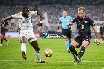 2024-05-08 - MADRID, SPAIN - MAY 8: Harry Kane of FC Bayern Munchen (R) seen in action against Antonio Rudiger of Real Madrid (L) during the UEFA Champions League semi-final second leg match between Real Madrid and FC Bayern Munchen at Estadio Santiago Bernabeu on May 8, 2024 in Madrid, Spain. - REAL MADRID VS BAYERN MUNICH - UEFA CHAMPIONS LEAGUE - SOCCER