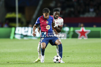 2024-10-23 - Lamine Yamal of FC Barcelona and Alphonso Davies of Bayern Munich during the UEFA Champions League, League phase, Matchday 3 football match between FC Barcelona and Bayern Munich on 23 October 2024 at Estadi Olímpic Lluís Companys in Barcelona, Spain - FOOTBALL - CHAMPIONS LEAGUE - FC BARCELONA V BAYERN MUNICH - UEFA CHAMPIONS LEAGUE - SOCCER