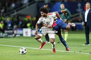 2024-10-23 - Serge Gnabry of Bayern Munich and Jules Kounde of FC Barcelona during the UEFA Champions League, League phase, Matchday 3 football match between FC Barcelona and Bayern Munich on 23 October 2024 at Estadi Olímpic Lluís Companys in Barcelona, Spain - FOOTBALL - CHAMPIONS LEAGUE - FC BARCELONA V BAYERN MUNICH - UEFA CHAMPIONS LEAGUE - SOCCER