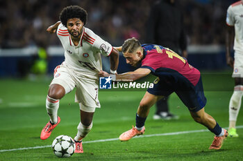 2024-10-23 - Serge GNABRY of Bayern Munich and Fermin LOPEZ of Barcelona during the UEFA Champions League, League Phase MD3 football match between FC Barcelona and Bayern Munich on 23 October 2024 at Estadi Olimpic Lluis Companys in Barcelona, Spain - FOOTBALL - CHAMPIONS LEAGUE - FC BARCELONA V BAYERN MUNICH - UEFA CHAMPIONS LEAGUE - SOCCER