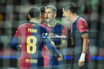 2024-10-23 - Robert LEWANDOWSKI of Barcelona celebrate his goal with Pedro GONZALEZ LOPEZ (Pedri) of Barcelona and Inigo MARTINEZ of Barcelona during the UEFA Champions League, League Phase MD3 football match between FC Barcelona and Bayern Munich on 23 October 2024 at Estadi Olimpic Lluis Companys in Barcelona, Spain - FOOTBALL - CHAMPIONS LEAGUE - FC BARCELONA V BAYERN MUNICH - UEFA CHAMPIONS LEAGUE - SOCCER