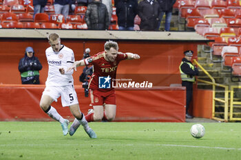 2023-12-14 - Nicky Devlin (2) of Aberdeen goes down in the box, Hrvoje Smolcic (5) of Eintracht Frankfurt during the UEFA Europa Conference League, Group G football match between Aberdeen and Eintracht Frankfurt on 14 December 2023 at Pittodrie Stadium in Aberdeen, Scotland - FOOTBALL - CONFERENCE LEAGUE - ABERDEEN V FRANKFURT - UEFA CONFERENCE LEAGUE - SOCCER