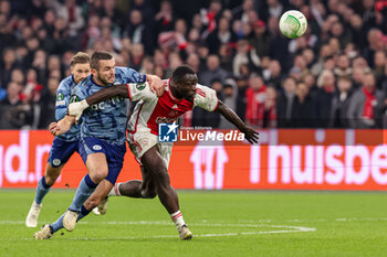 2024-03-07 - John McGinn of Aston Villa FC is tackling Brian Brobbey of AFC Ajax during the UEFA Europa Conference League, Round of 16, 1st leg football match between AFC Ajax and Aston Villa FC on March 7, 2024 at Johan Cruijff ArenA in Amsterdam, Netherlands - FOOTBALL - CONFERENCE LEAGUE - AJAX V ASTON VILLA - UEFA CONFERENCE LEAGUE - SOCCER