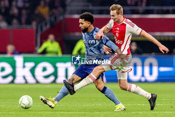 2024-03-07 - Douglas Luiz of Aston Villa FC battles for possession with Sivert Mannsverk of AFC Ajax during the UEFA Europa Conference League, Round of 16, 1st leg football match between AFC Ajax and Aston Villa FC on March 7, 2024 at Johan Cruijff ArenA in Amsterdam, Netherlands - FOOTBALL - CONFERENCE LEAGUE - AJAX V ASTON VILLA - UEFA CONFERENCE LEAGUE - SOCCER