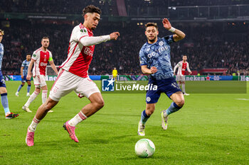 2024-03-07 - Tristan Gooijer of AFC Ajax battles for possession with Alex Moreno of Aston Villa during the UEFA Europa Conference League, Round of 16, 1st leg football match between AFC Ajax and Aston Villa FC on March 7, 2024 at Johan Cruijff ArenA in Amsterdam, Netherlands - FOOTBALL - CONFERENCE LEAGUE - AJAX V ASTON VILLA - UEFA CONFERENCE LEAGUE - SOCCER