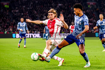 2024-03-07 - Borna Sosa of AFC Ajax battles for possession with Ollie Watkins of Aston Villa during the UEFA Europa Conference League, Round of 16, 1st leg football match between AFC Ajax and Aston Villa FC on March 7, 2024 at Johan Cruijff ArenA in Amsterdam, Netherlands - FOOTBALL - CONFERENCE LEAGUE - AJAX V ASTON VILLA - UEFA CONFERENCE LEAGUE - SOCCER