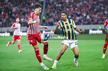 2024-04-11 - 45 Panagiotis Retsos of Olympiacos Piraeus competing with 24 Jayden Oosterwolde of Fenerbahce during the UEFA Conference League, Quarter-finals, 1st leg, match between Olympiacos Piraeus and Fenerbahce at Georgios Karaiskakis Stadium on April 11, 2024, in Piraeus, Greece. - OLYMPIACOS VS FENERBAHCE - QUARTER-FINALS, 1ST LEG - UEFA CONFERENCE LEAGUE - SOCCER