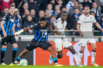 2024-04-11 - Raphael Onyedika of Club Brugge battles for the ball with Mbwana Samatta of PAOK during the UEFA Europa Conference League, Quarter-finals, 1st leg football match between Club Brugge KV and PAOK Saloniki on April 11, 2024 at Jan Breydelstadion in Brugge, Belgium - FOOTBALL - CONFERENCE LEAGUE - CLUB BRUGGE V PAOK - UEFA CONFERENCE LEAGUE - SOCCER