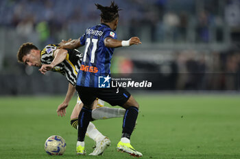 2024-05-15 - Juventus' Serbian forward Dusan Vlahovic challenges for the ball with Atalanta's Nigerian forward Ademola Lookman during the Italian Cup final football match between Atalanta and Juventus at Stadio Olimpico on May 15,2024 in Rome, Italy. - FINAL - JUVENTUS FC VS ATALANTA BC - ITALIAN CUP - SOCCER