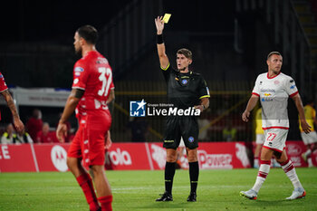 2024-08-09 - Francesco Cosso (Referee) shows the yellow card - AC MONZA VS FC SUDTIROL - ITALIAN CUP - SOCCER