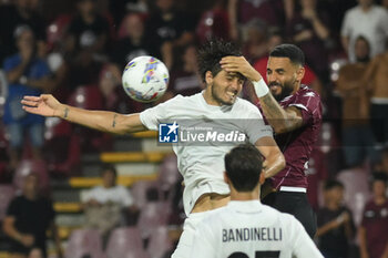 2024-08-12 - Dylan Bronn of US Salernitana 1919 competes for the ball with Diego Falcinelli of Spezia Calcio during the Soccer Italian Cup Freccia Rossa between US Salernitana 1919 vs Spezia Calcio at Arechi Stadium - US SALERNITANA VS SPEZIA CALCIO - ITALIAN CUP - SOCCER