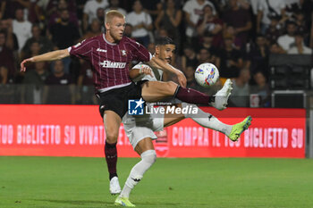 2024-08-12 - Diego Falcinelli of Spezia Calcio competes for the ball with Tijs Velthhuis of US Salernitana 1919 during the Soccer Italian Cup Freccia Rossa between US Salernitana 1919 vs Spezia Calcio at Arechi Stadium - US SALERNITANA VS SPEZIA CALCIO - ITALIAN CUP - SOCCER