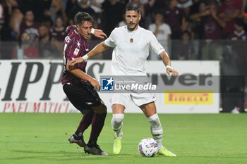 2024-08-12 - Diego Falcinelli of Spezia Calcio competes for the ball with Gregorio Salvati of US Salernitana 1919 during the Soccer Italian Cup Freccia Rossa between US Salernitana 1919 vs Spezia Calcio at Arechi Stadium - US SALERNITANA VS SPEZIA CALCIO - ITALIAN CUP - SOCCER