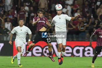 2024-08-12 - Lorenzo Amatucci of US Salernitana 1919 competes for the ball with Diego Falcinelli of Spezia Calcio during the Soccer Italian Cup Freccia Rossa between US Salernitana 1919 vs Spezia Calcio at Arechi Stadium - US SALERNITANA VS SPEZIA CALCIO - ITALIAN CUP - SOCCER