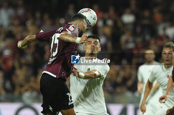 2024-08-12 - Dylan Bronn of US Salernitana 1919 competes for the ball with Salvatore Esposito of Spezia Calcio during the Soccer Italian Cup Freccia Rossa between US Salernitana 1919 vs Spezia Calcio at Arechi Stadium - US SALERNITANA VS SPEZIA CALCIO - ITALIAN CUP - SOCCER