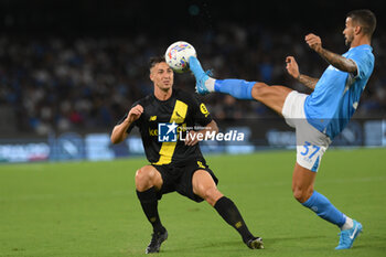 2024-08-10 - Leonardo Spinazoila of SSC Napoli competes for the ball with Simone Santoro of Modena FC during the Soccer Italian Cup Freccia Rossa between SSC Napoli vs Modena FC at Diego Armando Maradona Stadium - SSC NAPOLI VS MODENA FC - ITALIAN CUP - SOCCER