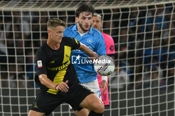 2024-08-10 - Khvicha Kvaratskhelia of SSC Napoli competes for the ball with Simone Santoro of Modena FC during the Soccer Italian Cup Freccia Rossa between SSC Napoli vs Modena FC at Diego Armando Maradona Stadium - SSC NAPOLI VS MODENA FC - ITALIAN CUP - SOCCER