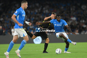 2024-08-10 - Zambo Anguissa of SSC Napoli competes for the ball with Fabio Ponsi of Modena FC during the Soccer Italian Cup Freccia Rossa between SSC Napoli vs Modena FC at Diego Armando Maradona Stadium - SSC NAPOLI VS MODENA FC - ITALIAN CUP - SOCCER