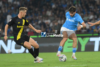 2024-08-10 - Khvicha Kvaratskhelia of SSC Napoli competes for the ball with Simone Santoro of Modena FC during the Soccer Italian Cup Freccia Rossa between SSC Napoli vs Modena FC at Diego Armando Maradona Stadium - SSC NAPOLI VS MODENA FC - ITALIAN CUP - SOCCER