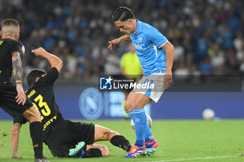 2024-08-10 - Giacomo Raspadoria of SSC Napoli competes for the ball with Mattia Caldara of Modena FC during the Soccer Italian Cup Freccia Rossa between SSC Napoli vs Modena FC at Diego Armando Maradona Stadium - SSC NAPOLI VS MODENA FC - ITALIAN CUP - SOCCER