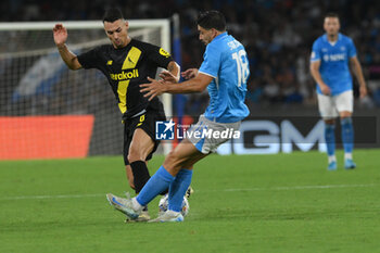 2024-08-10 - Giovanni Simeone of SSC Napoli competes for the ball with Luca Magnino of Modena FC during the Soccer Italian Cup Freccia Rossa between SSC Napoli vs Modena FC at Diego Armando Maradona Stadium - SSC NAPOLI VS MODENA FC - ITALIAN CUP - SOCCER