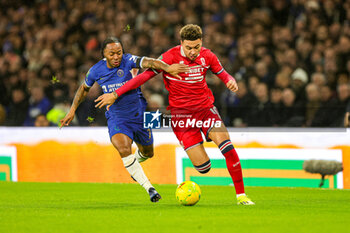 2024-01-23 - Raheem Sterling (7) of Chelsea tussles with Morgan Rogers (10) of Middlesbrough during the English League Cup, EFL Cup, semi final second leg football match between Chelsea and Middlesbrough on 23 January 2024 at Stamford Bridge in London, England - FOOTBALL - ENGLISH LEAGUE CUP - CHELSEA V MIDDLESBROUGH - ENGLISH LEAGUE CUP - SOCCER