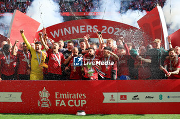 2024-05-25 - Manchester United players celebrate with the trophy after the 1-2 victory during the English FA Cup, Final football match between Manchester City and Manchester United on 25 May 2024 at Wembley Stadium in London, England - FOOTBALL - ENGLISH CUP - FINAL - MANCHESTER CITY V MANCHESTER UNITED - ENGLISH LEAGUE CUP - SOCCER