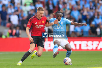 2024-05-25 - Jeremy Doku (11) of Manchester City and Scott McTominay (39) of Manchester United during the English FA Cup, Final football match between Manchester City and Manchester United on 25 May 2024 at Wembley Stadium in London, England - FOOTBALL - ENGLISH CUP - FINAL - MANCHESTER CITY V MANCHESTER UNITED - ENGLISH LEAGUE CUP - SOCCER