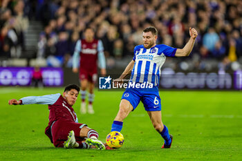 2024-01-03 - Edson Alvarez (19) of West Ham United slides in and tackles James Milner (6) of Brighton & Hove Albion during the English championship Premier League football match between West Ham United and Brighton and Hove Albion on 2 January 2024 at the London Stadium in London, England - FOOTBALL - ENGLISH CHAMP - WEST HAM V BRIGHTON - ENGLISH PREMIER LEAGUE - SOCCER