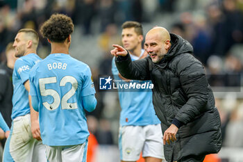 2024-01-13 - Manchester City manager Pep Guardiola celebrates with Oscar Bobb of Manchester City at the full time during the English championship Premier League football match between Newcastle United and Manchester City on 13 January 2024 at St. James' Park in Newcastle, England - FOOTBALL - ENGLISH CHAMP - NEWCASTLE V MANCHESTER CITY - ENGLISH PREMIER LEAGUE - SOCCER