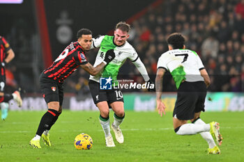 2024-01-21 - Justin Kluivert (19) of AFC Bournemouth battles for possession with Alexis Mac Allister (10) of Liverpool during the English championship Premier League football match between Bournemouth and Liverpool on 21 January 2024 at the Vitality Stadium in Bournemouth, England - FOOTBALL - ENGLISH CHAMP - BOURNEMOUTH V LIVERPOOL - ENGLISH PREMIER LEAGUE - SOCCER