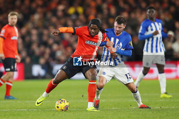 2024-01-30 - Luton Town Midfielder Pelly Ruddock Mpanzu (17) under pressure from Brighton Hove Albion Midfielder Pascal Gross (13) during the English championship Premier League football match between Luton Town and Brighton and Hove Albion on 30 January 2024 at Kenilworth Road in Luton, England - FOOTBALL - ENGLISH CHAMP - LUTON TOWN V BRIGHTON - ENGLISH PREMIER LEAGUE - SOCCER