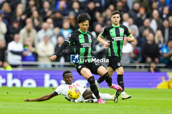 2024-02-11 - Pape Matar Sarr (29) of Tottenham Hotspur slides in and tackles Kaoru Mitoma (22) of Brighton & Hove Albion during the English championship Premier League football match between Tottenham Hotspur and Brighton and Hove Albion on 10 February 2024 at Tottenham Hotspur Stadium in London, England - FOOTBALL - ENGLISH CHAMP - TOTTENHAM V BRIGHTON - ENGLISH PREMIER LEAGUE - SOCCER