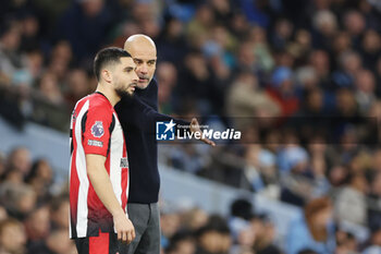 2024-02-20 - Manchester City manager Pep Guardiola talks to Neal Maupay of Brentford during the English championship Premier League football match between Manchester City and Brentford on 20 February 2024 at the Etihad Stadium in Manchester, England - FOOTBALL - ENGLISH CHAMP - MANCHESTER CITY V BRENTFORD - ENGLISH PREMIER LEAGUE - SOCCER