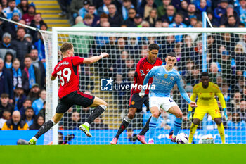 2024-03-04 - Phil Foden (47) of Manchester City and Scott McTominay, Raphael Varane of Manchester United during the English championship Premier League football match between Manchester City and Manchester United on 3 March 2024 at the Etihad Stadium in Manchester, England - FOOTBALL - ENGLISH CHAMP - MANCHESTER CITY V MANCHESTER UNITED - ENGLISH PREMIER LEAGUE - SOCCER