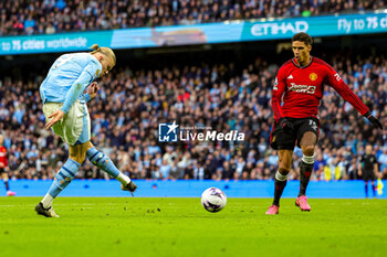2024-03-04 - Erling Haaland (9) of Manchester City scores a goal 3-1, Raphael Varane of Manchester United during the English championship Premier League football match between Manchester City and Manchester United on 3 March 2024 at the Etihad Stadium in Manchester, England - FOOTBALL - ENGLISH CHAMP - MANCHESTER CITY V MANCHESTER UNITED - ENGLISH PREMIER LEAGUE - SOCCER